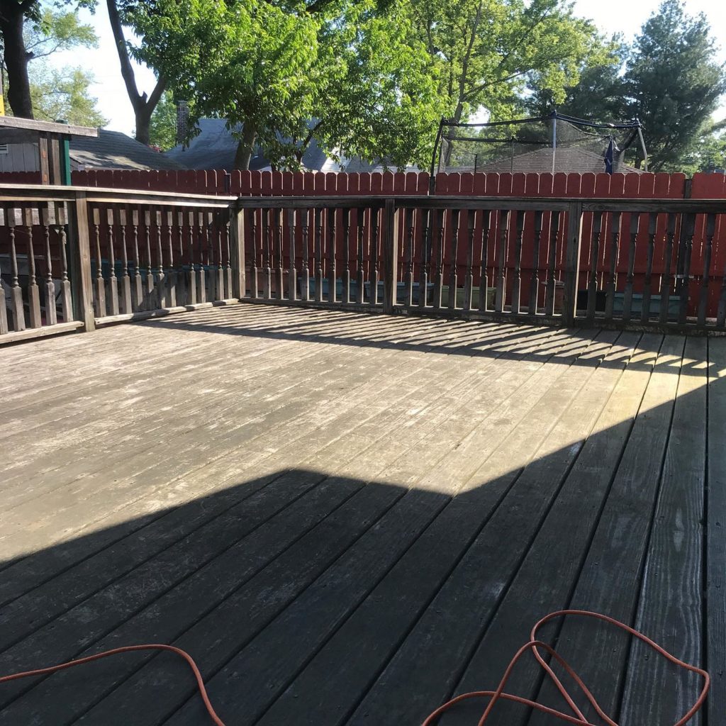 A wooden floor with a wooden fence, creating a rustic and charming outdoor space