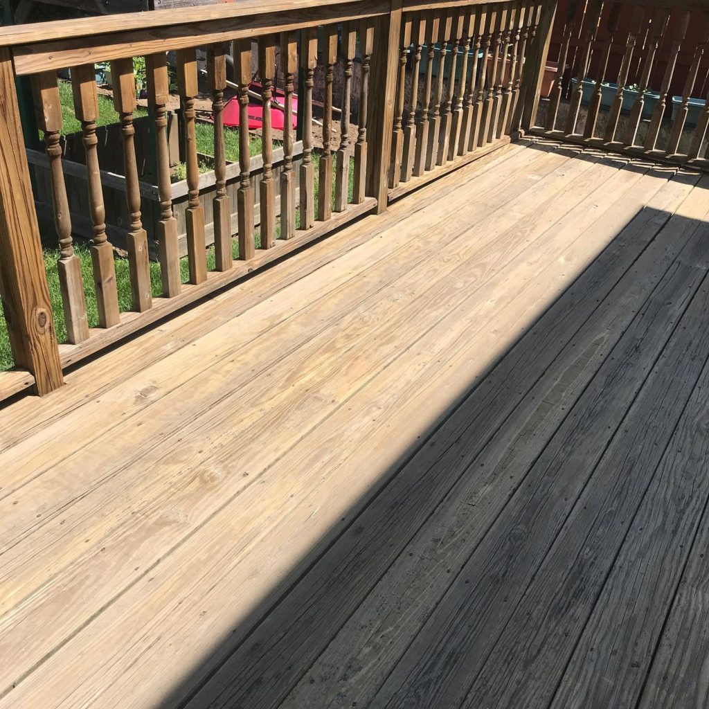 A wooden floor with a wooden fence, creating a rustic and charming outdoor space