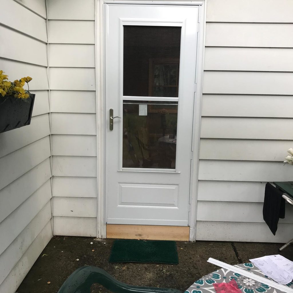 The before look of a white front home, showing its original appearance prior to any changes or renovations