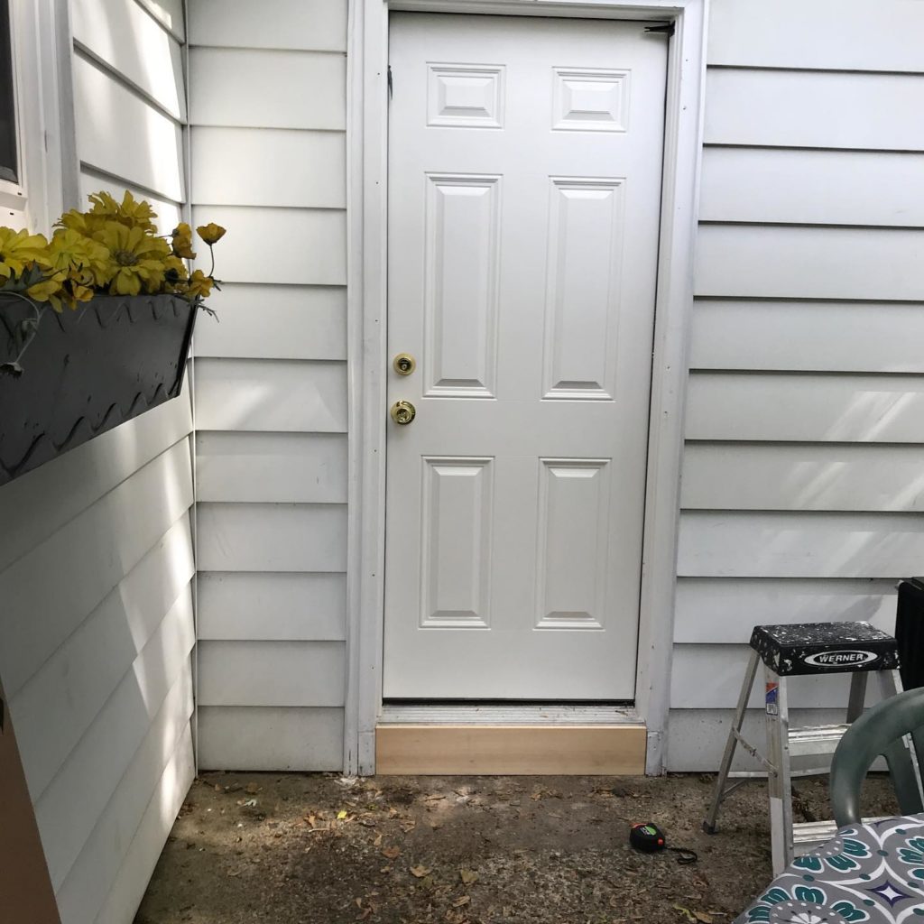 A white front house with a white door, creating a clean and bright entryway